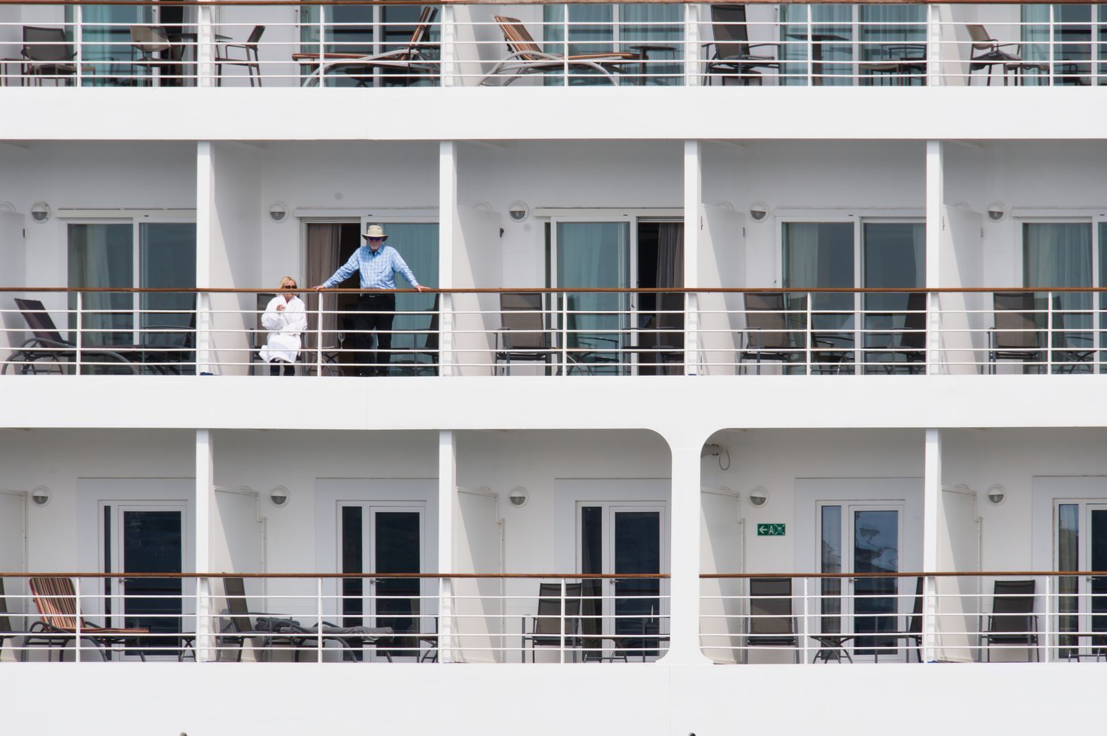 Guests on cruise ship cabin balconies, choosing the best cruise rewards program for how they sail