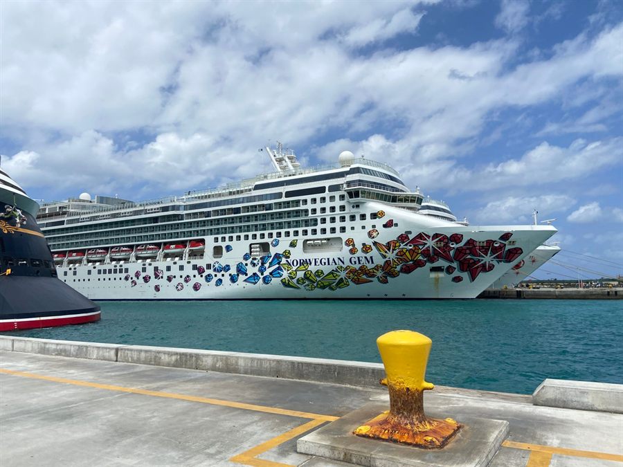 Norwegian Gem cruise ship docked at Nassau port under a bright blue sky