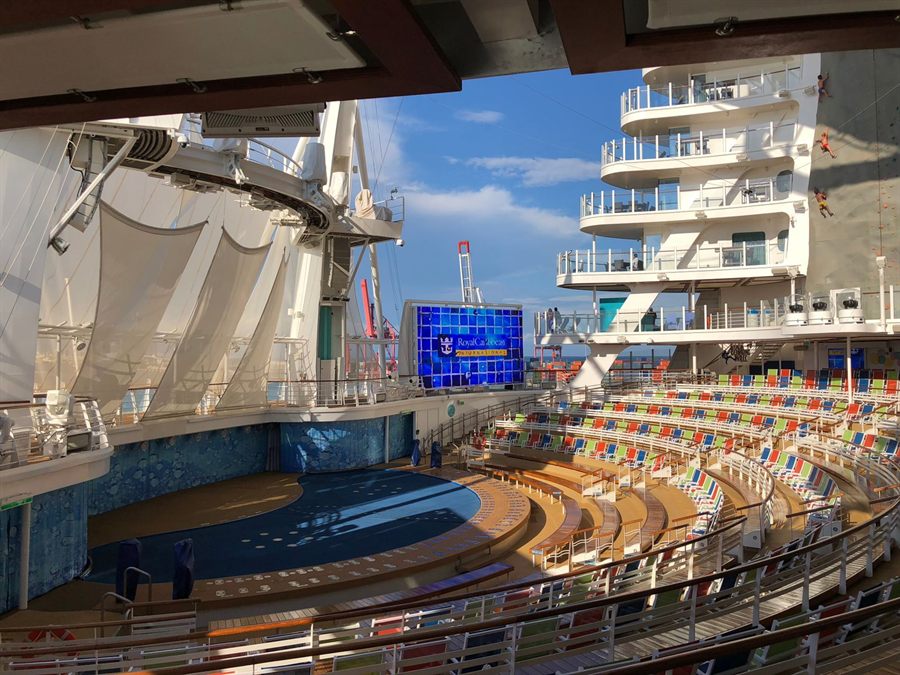 Open-air amphitheater with tiered seating at the stern of a large cruise ship