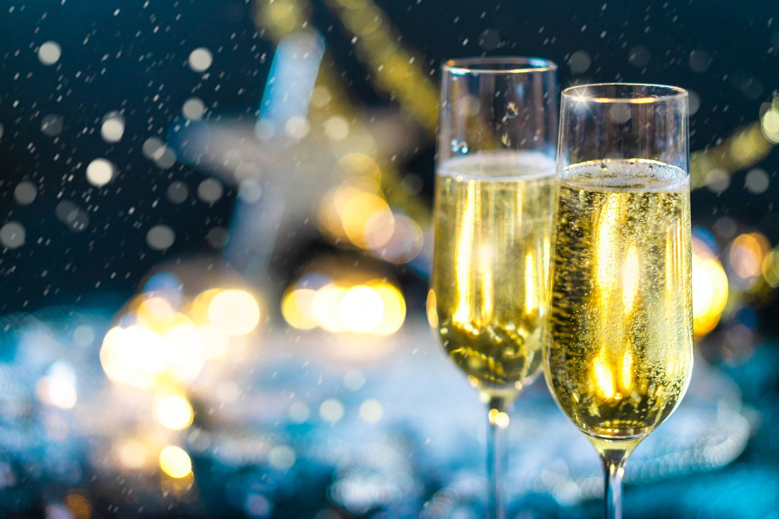 Two champagne glasses with sparkling bubbles, a welcome-back toast weighed in a cruise loyalty program comparison