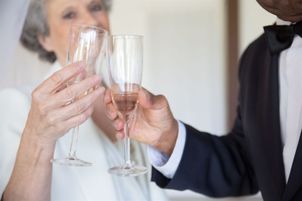 Senior couple in formal attire toasting with champagne