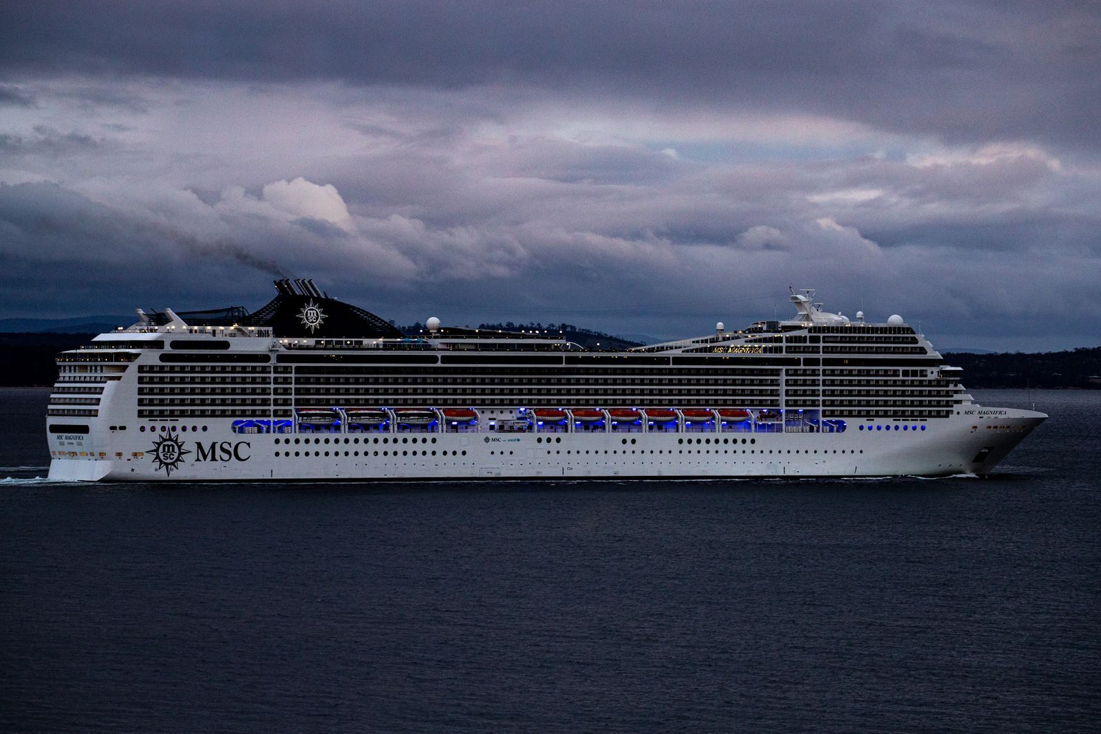 MSC cruise ship sailing near Hobart under a dramatic cloudy sky